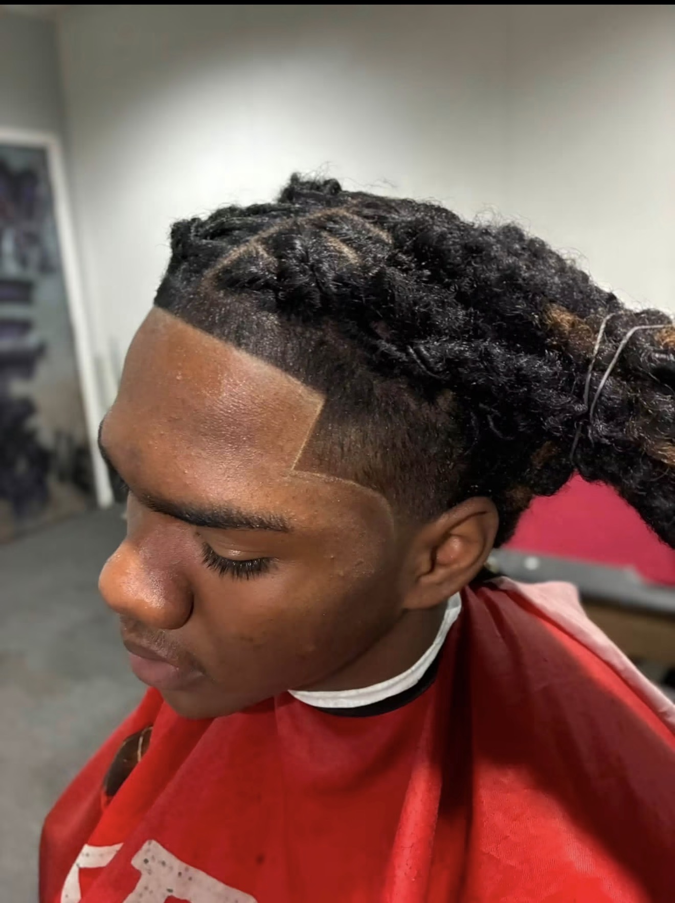 Locs styled with a clean shape-up